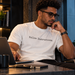Man wearing Follow Instructions Typewriter men's white graphic tee